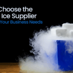 Dry ice blocks emitting fog in a blue container on a wooden surface.