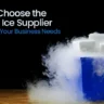 Dry ice blocks emitting fog in a blue container on a wooden surface.